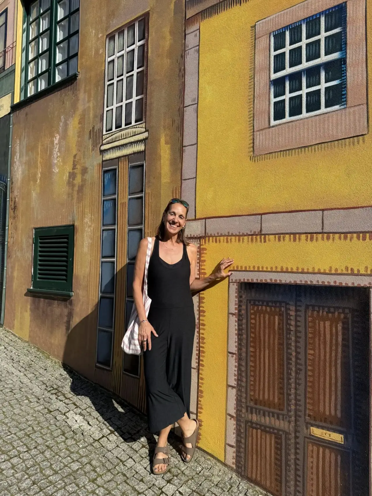 A woman standing in front of a building.